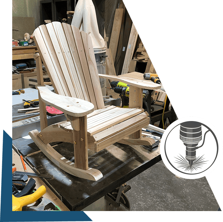 A wooden rocking chair sitting in the middle of a workshop.