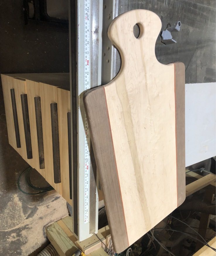 A wooden cutting board sitting on top of a table.