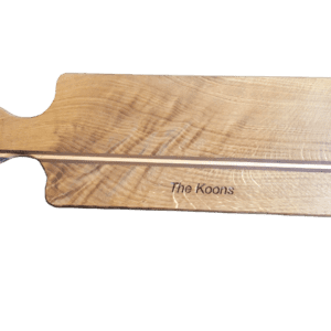 A wooden paddle with the name of the board engraved on it.