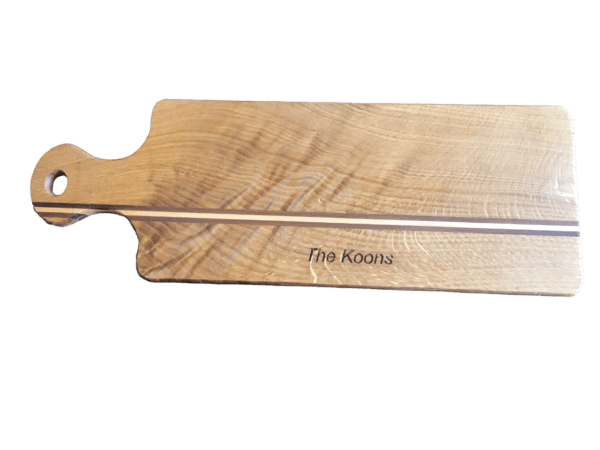 A wooden paddle with the name of the board engraved on it.