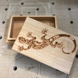 A wooden box with an image of a lizard on it.